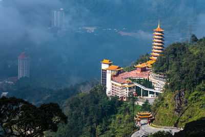 Panoramic view of buildings and trees against sky