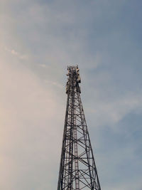 Low angle view of communications tower against sky