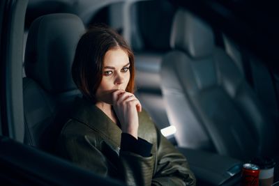 Portrait of young woman in car