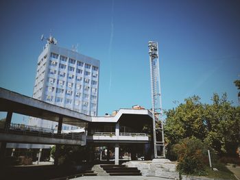 Low angle view of buildings against clear blue sky