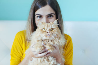 Portrait of young woman with cat