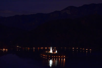 Scenic view of lake against sky at night