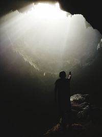 Silhouette man standing on mountain