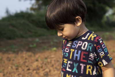 Boy standing on field