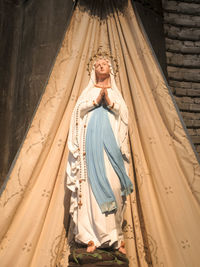 Low angle view of woman standing at temple