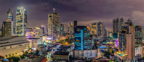 High angle view of city lit up at night