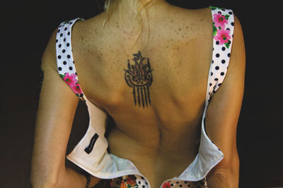 Rear view of woman with unzipped dress