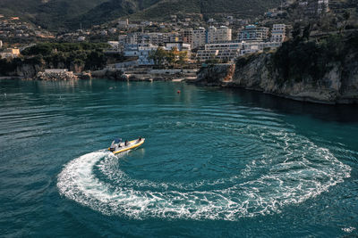 High angle view of sea and buildings in city