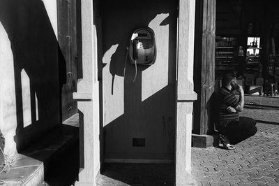 Woman with umbrella in front of building