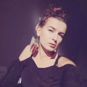 Portrait of beautiful young woman against gray background