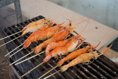 High angle view of meat on barbecue grill