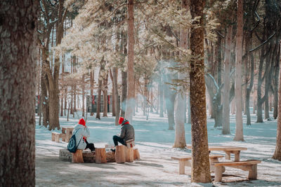 Rear view of man sitting on snow