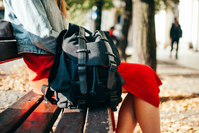 Low section of woman with umbrella walking outdoors