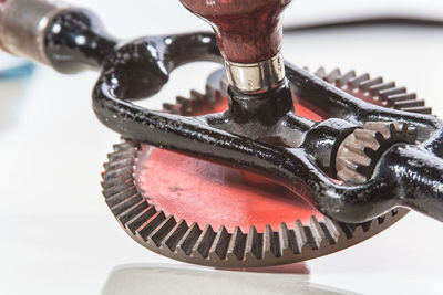 Close-up of metallic bottle opener on white background