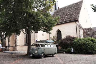 Car on street by buildings in city