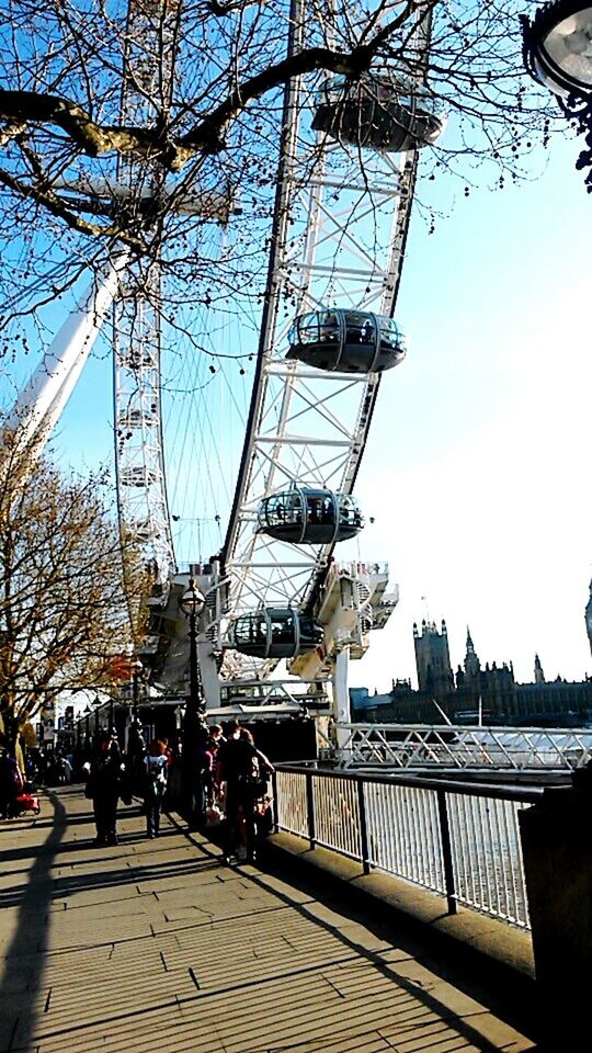 architecture, built structure, building exterior, men, person, lifestyles, city, leisure activity, clear sky, railing, walking, city life, transportation, bridge - man made structure, connection, large group of people, sunlight, travel, sky