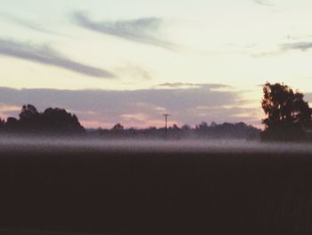 Scenic view of landscape against sky at sunset