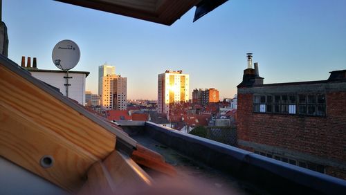 Buildings in city against clear sky