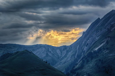 Scenic view of snowcapped mountains against sky during sunset