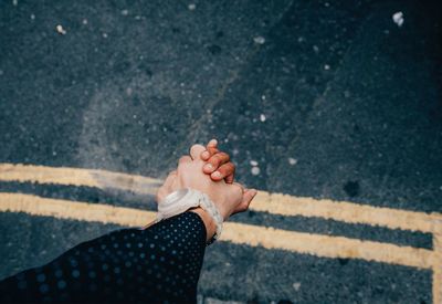 Close-up of cropped couple holding hands