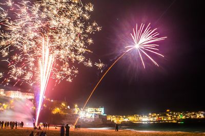 Low angle view of firework display at night