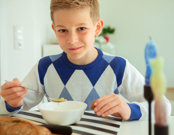 Portrait of boy holding ice cream in bowl