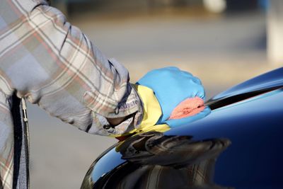 Close-up of person working on carwash 