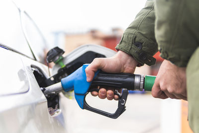 Man refueling car at gas station