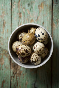 Quail eggs on a wooden table.