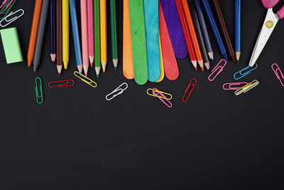 High angle view of multi colored pencils against black background