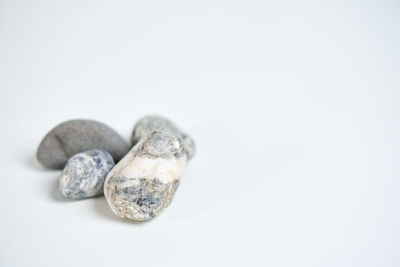 Close-up of pebbles against white background