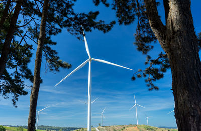 Low angle view of wind turbine against sky