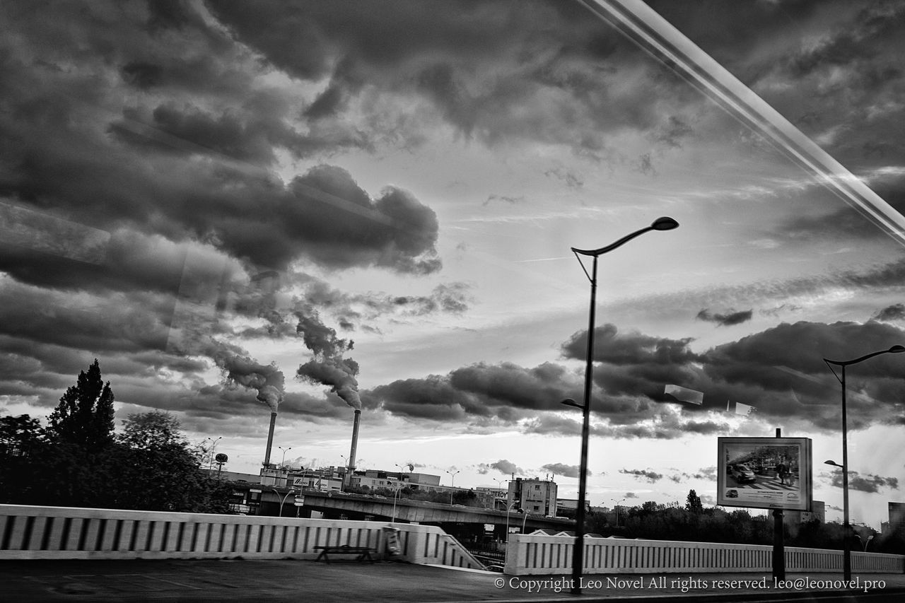 sky, cloud - sky, cloudy, street light, built structure, cloud, architecture, weather, building exterior, overcast, railing, transportation, city, low angle view, road, tree, storm cloud, lighting equipment, outdoors, street
