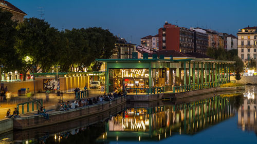 Reflection of illuminated buildings in water at dusk