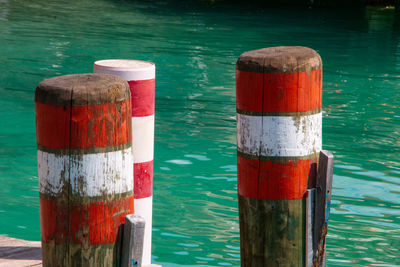 Red wooden post on pier over sea