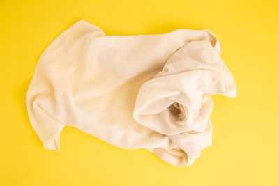 High angle view of white rose against yellow background