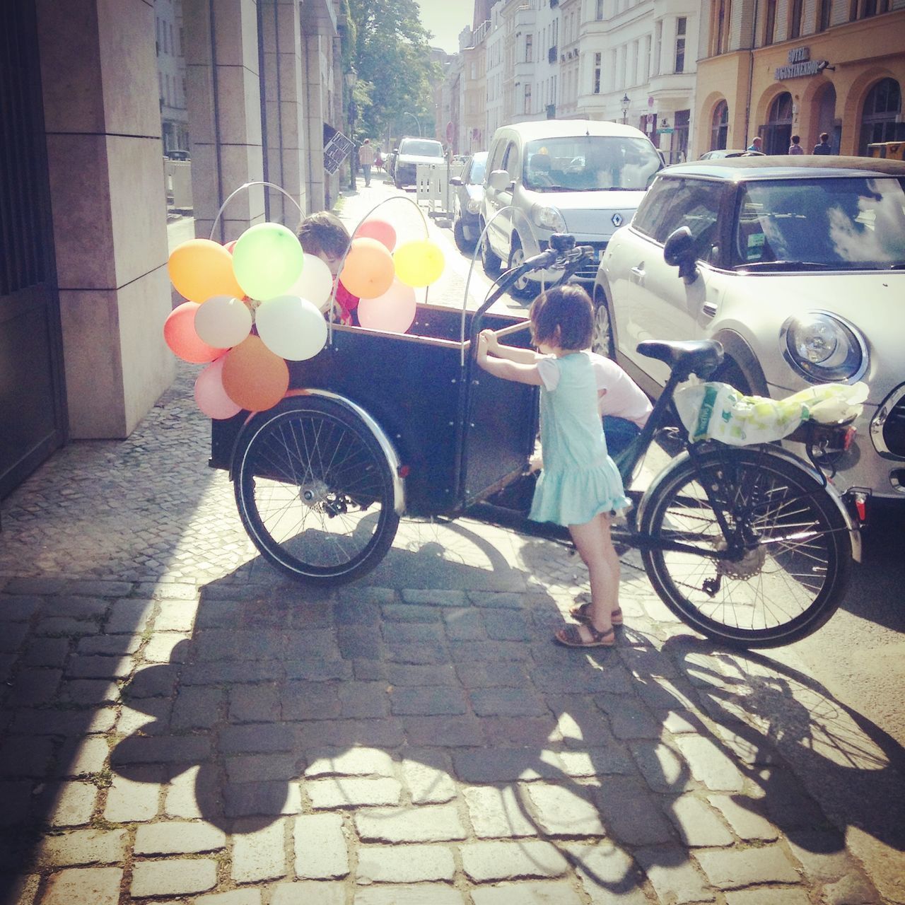 BICYCLES ON STREET IN FRONT OF BUILDING