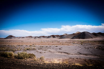 Scenic view of arid landscape against sky