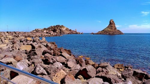 Panoramic view of sea against clear blue sky