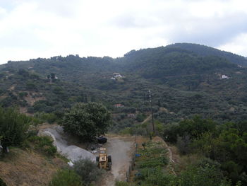 Scenic view of mountains against cloudy sky