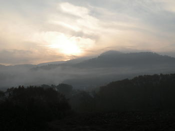 Scenic view of mountains against sky during sunset