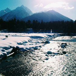 Frozen lake against mountain range