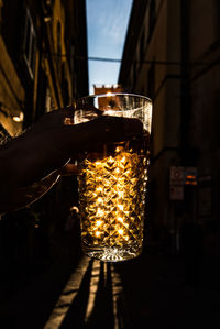 Cropped hand holding beer glass