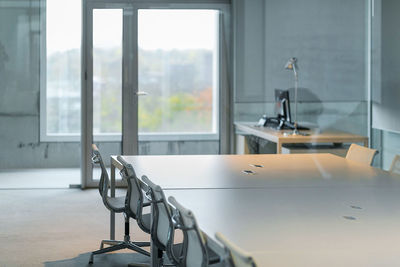 Empty chair by table in conference room