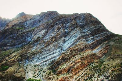 Low angle view of rocky mountain against sky