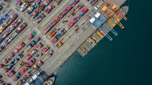 Aerial view of multi colored cargo container by lake