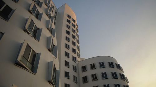 Low angle view of office building against sky