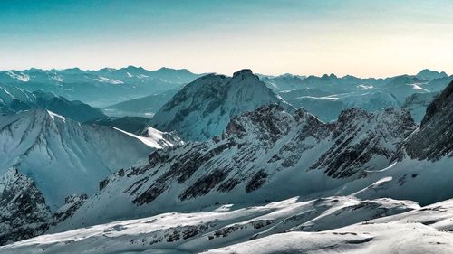 Scenic view of snowcapped mountains against clear sky