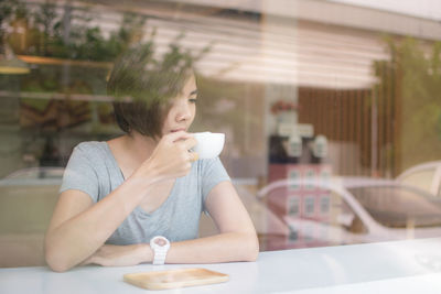 Woman sitting on table at restaurant