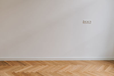 View of empty hardwood floor against wall at home